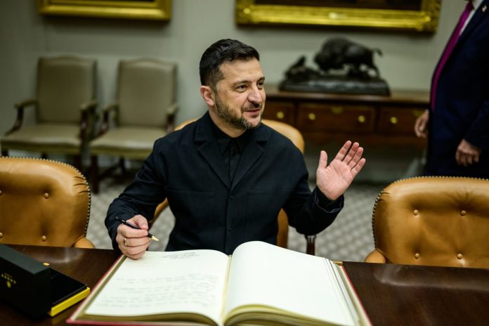 P20251017DT-0242 President Donald Trump looks on as Ukrainian President Volodymyr Zelenskyy signs the guestbook in the Roosevelt Room, Friday, October 17, 2025. (Official White House Photo by Daniel Torok)